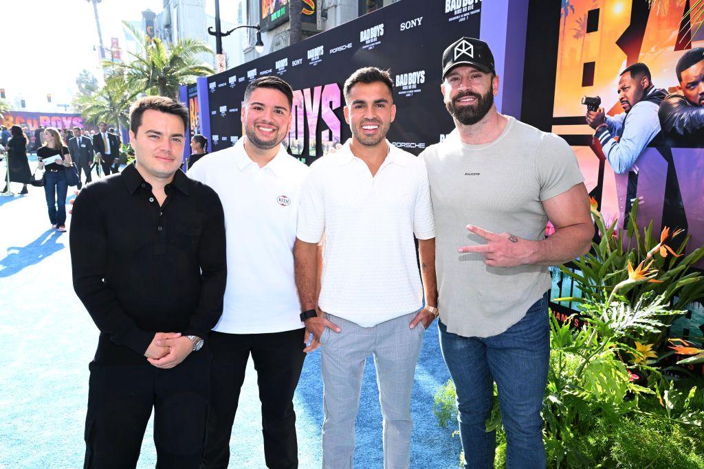 Four men standing in a line