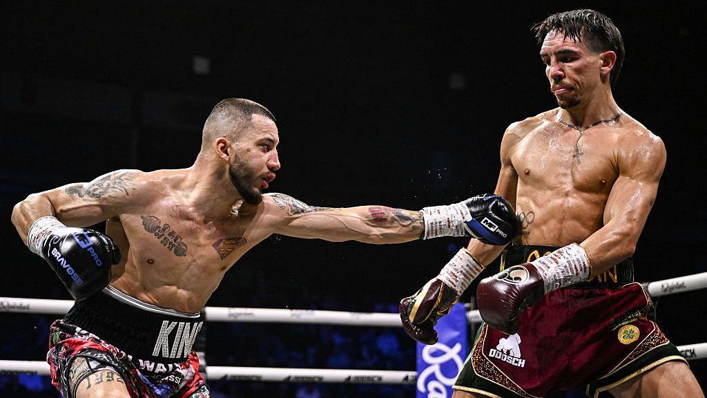 Walsh throws a left to the body of Conlan