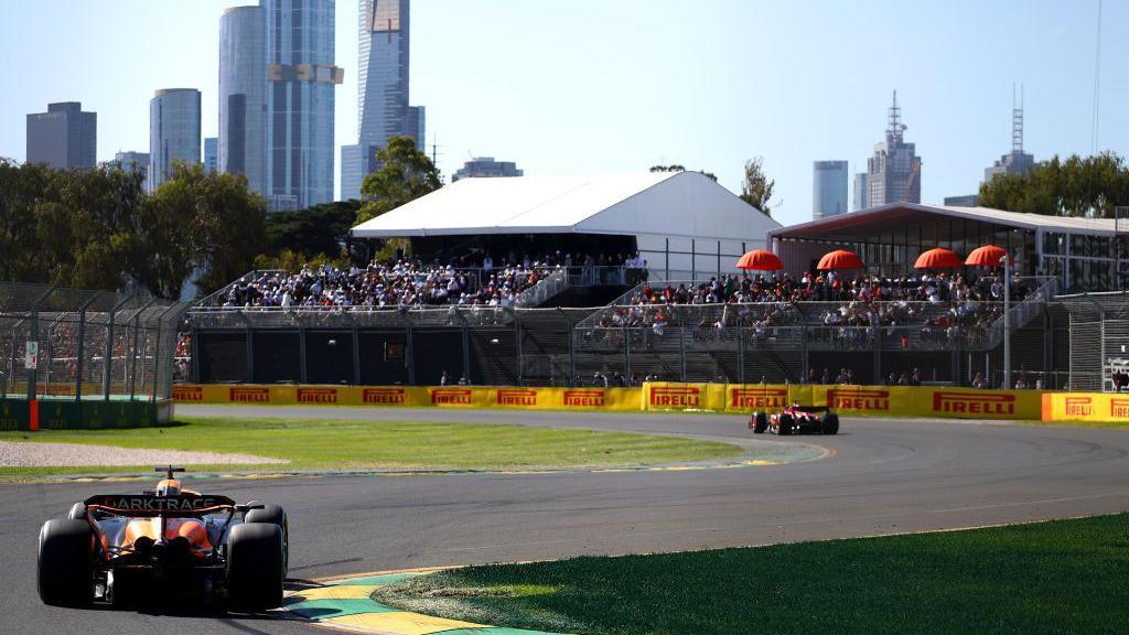 A rear view of McLaren's Oscar Piastri driving at the Australian Grand Prix in Albert Park, Melbourne