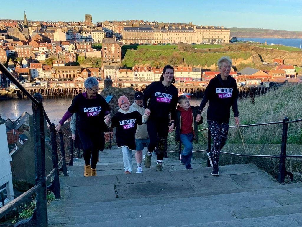 The trio along with Bryony's niece Isla and son Ted walking up the abbey steps 