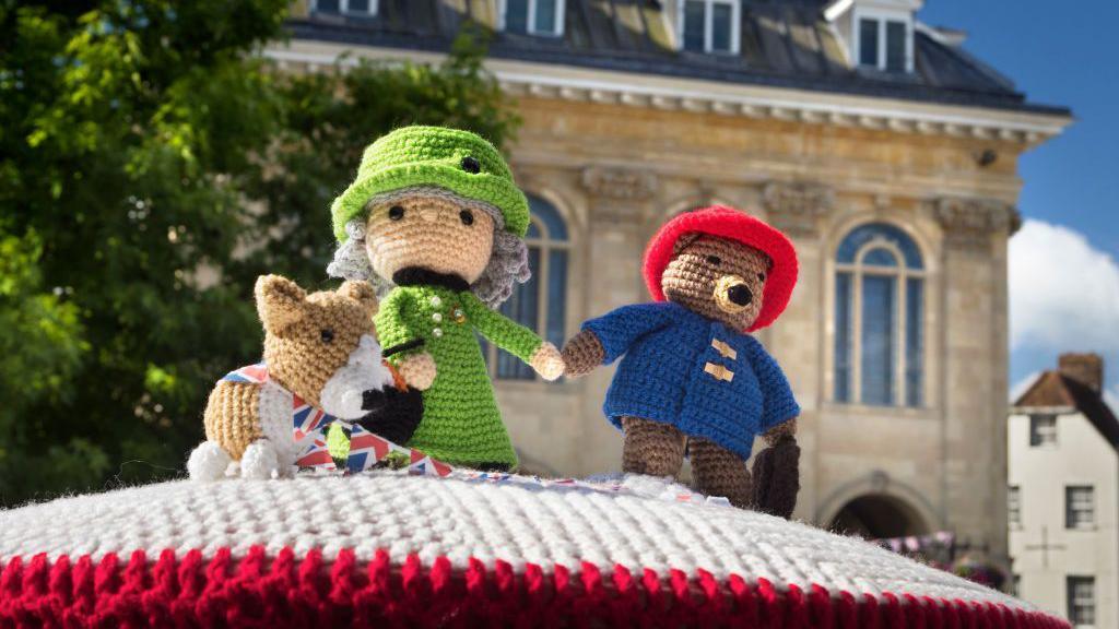 Knitted Queen Elizabeth with knitted corgi and Paddington Bear