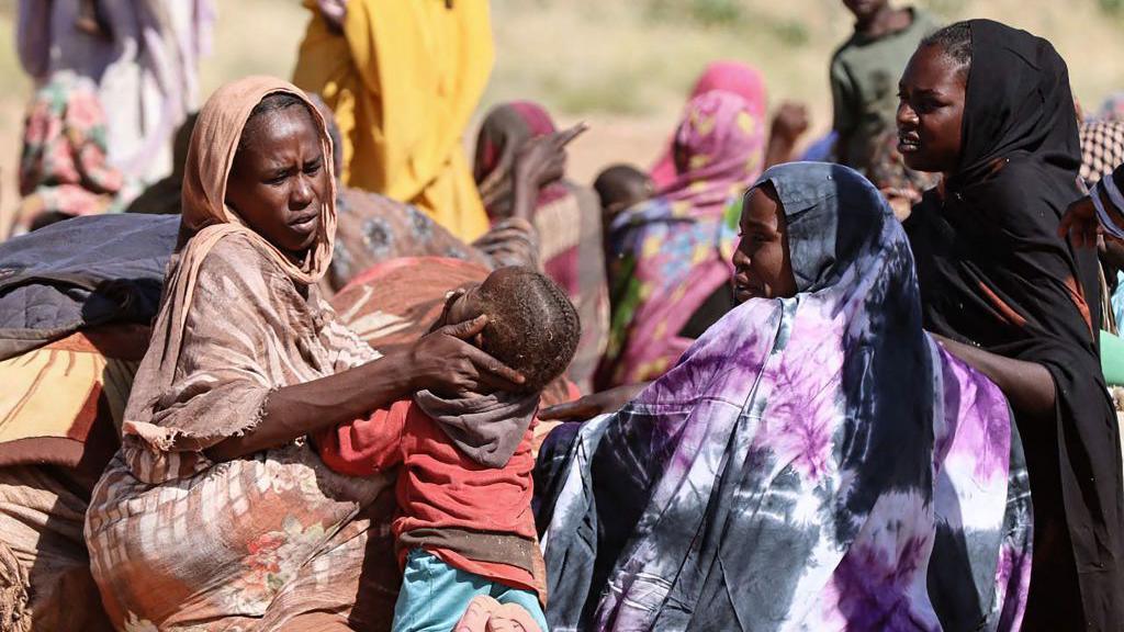 Displaced Sudanese women and children gather at a camp near the town of Tawila in North Darfur on February 11, 2025