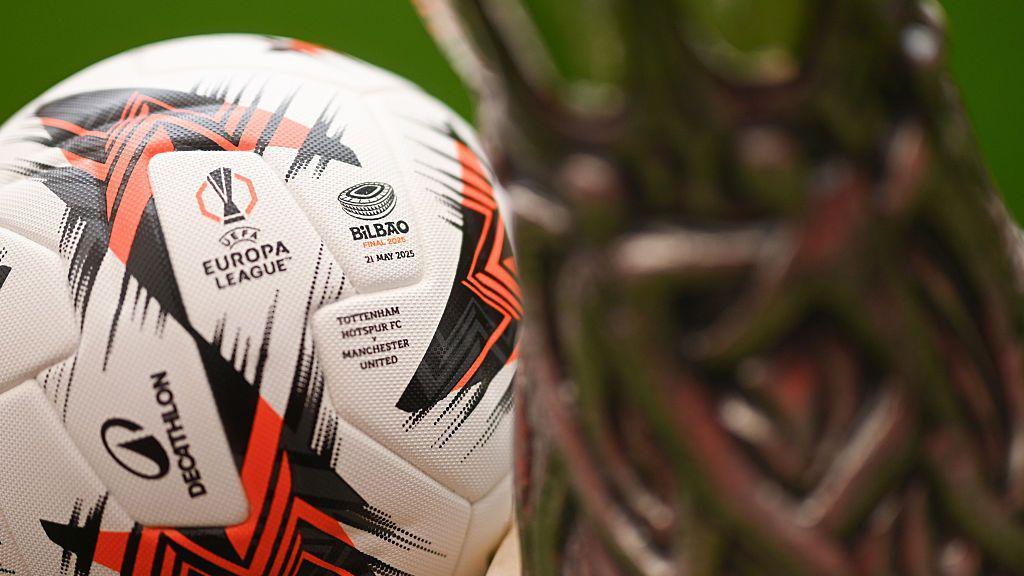 Close-up photo of the Europa League final ball and trophy.