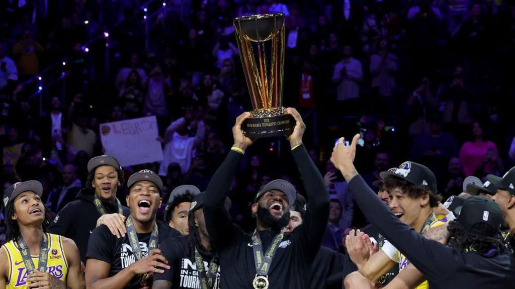 LeBron James lifts the 2023 NBA Cup trophy with the Los Angeles Lakers 