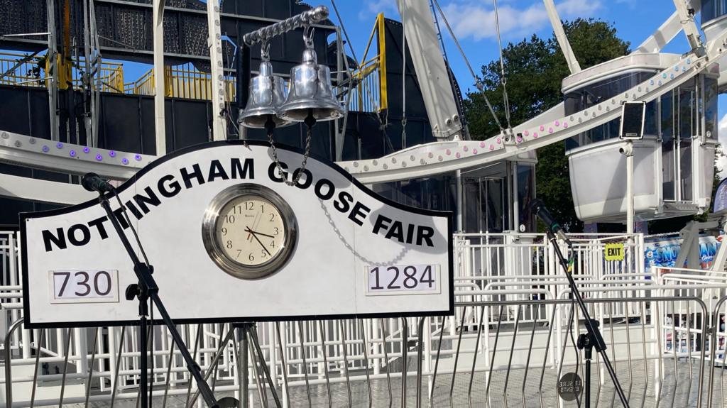 The Nottingham Goose Fair sign with a Ferris Wheel in the background