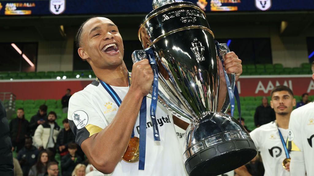 Kealey Adamson holds the Australia Cup trophy