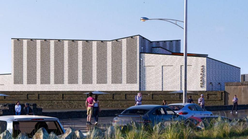 A computer drawn rendering of a grey building with an angled roof. The word "Tropicana" is placed vertically on the building.
