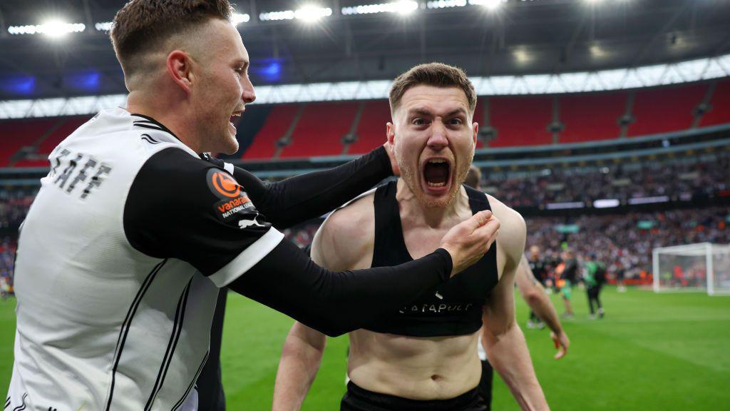 Cedwyn Scott of Notts County celebrates after scoring the team's fifth penalty during the penalty shootout to secure promotion to League Two