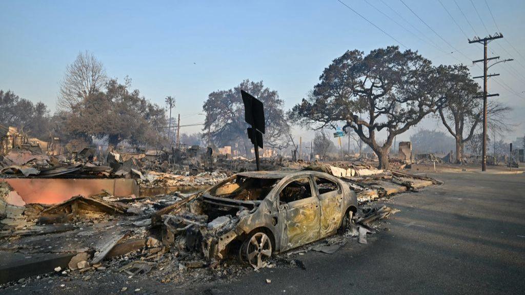 Burned-out cars and homes reduced to rubble by the Eaton Fire are seen in Altadena, California