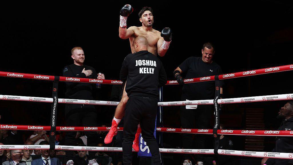 Josh Kelly is lifted into the air by his coach celebrating