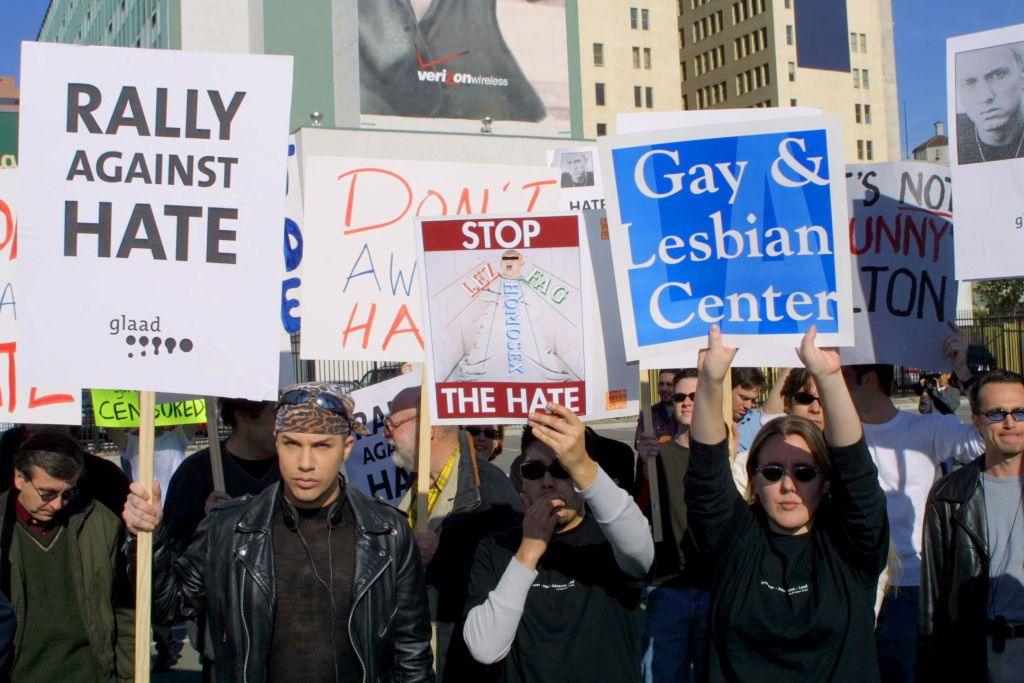 Protesters hold up signs during The Rally Against Hate to push back against Eminem's lyrics ahead of the 2001 Grammy