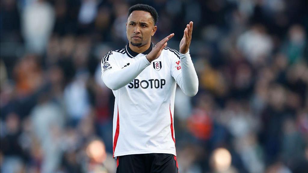Kenny Tete of Fulham applauds the fans