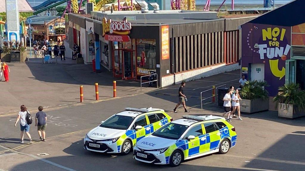 Two Essex Police vehicles in Southend, with people walking nearby