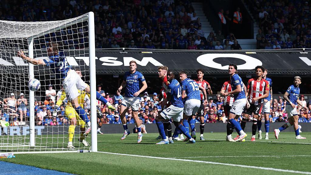 Brentford's Kevin Schade scores with a header against Ipswich Town in the Premier League