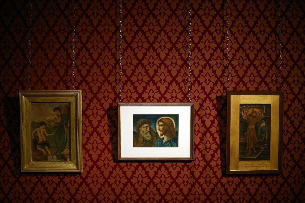 William De Morgan titled 'Tobias and the Angel at the River Tigris', 'Christ and Peter' by Simeon Solomon and 'The Wine Press' by John Roddam Spencer Stanhope are pictured during a preview at Leighton House Museum in February 2016
