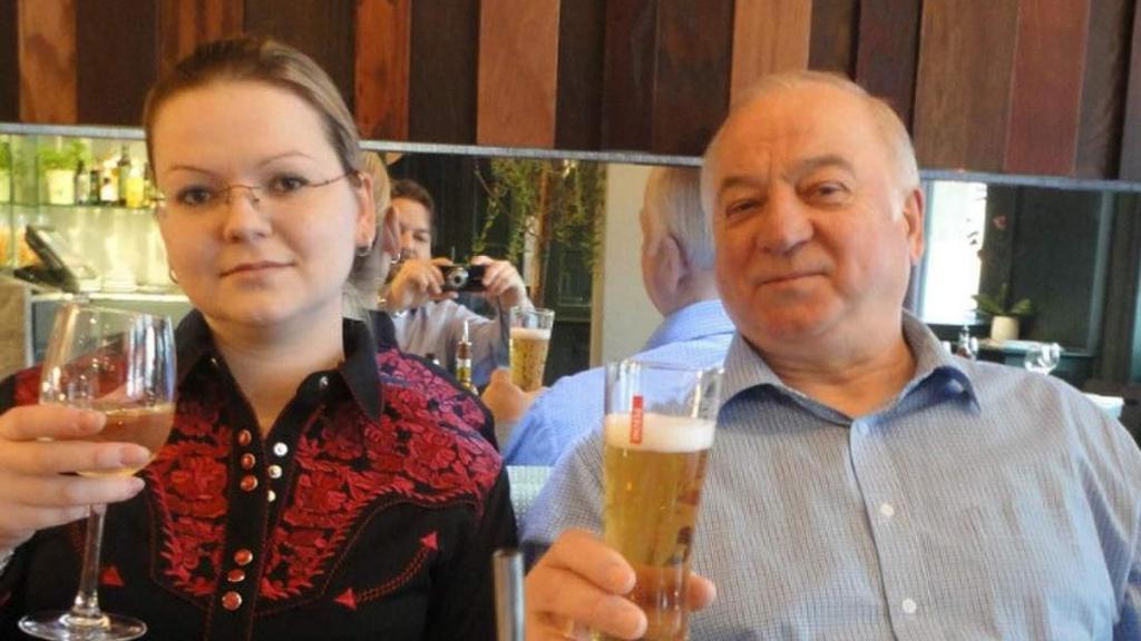 Yulia and Sergei Skripal in a restaurant holding beers