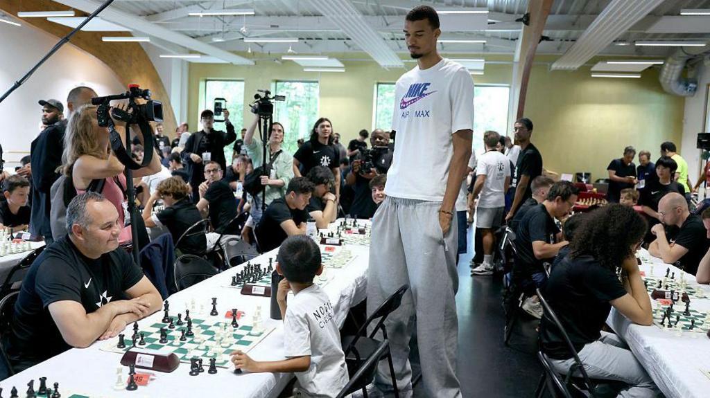 Victor Wembanyama watches over chess matches