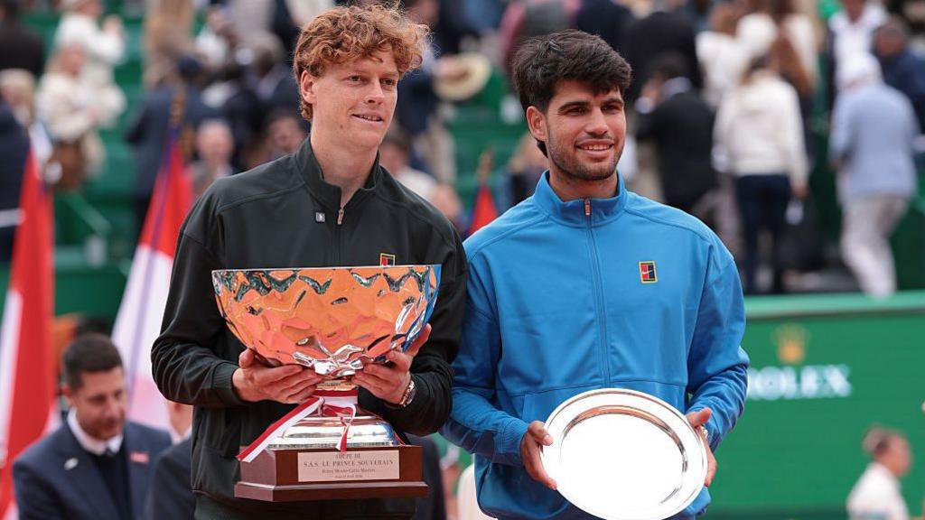 Jannik Sinner and Carlos Alcaraz hold trophies at the Monte Carlo Open