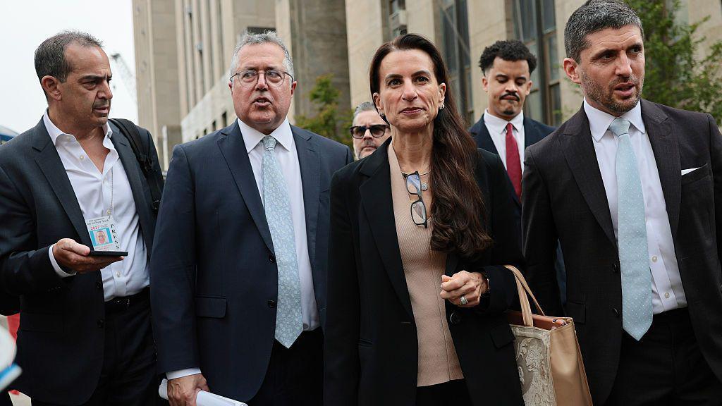 Mangione's defence team leave court. Pictured from left to right: Marc Agnifilo, Karen Friedman Agnifilo, and Jacob Kaplan.