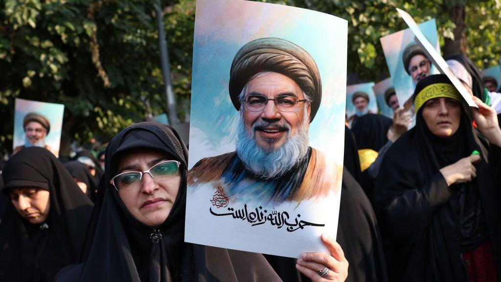 Iranian women hold pictures of Hezbollah leader Hassan Nasrallah, who was killed in an Israeli air strike on Beirut's southern suburbs on September 27.