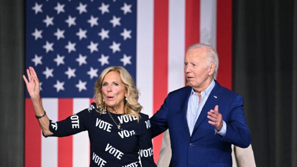 Joe and Jill Biden standing in front of an American flag