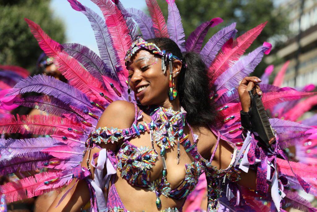 A woman dances during a parade at the Notting Hill Carnival