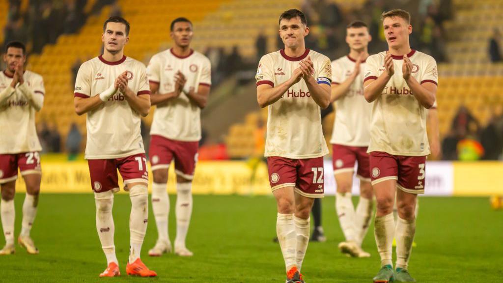 Bristol City players applaud the fans on the pitch after the full-time whistle against Norwich