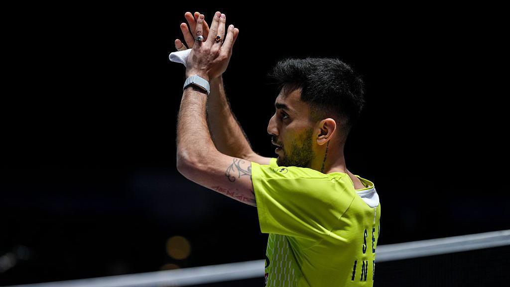 Lakshyar Sen of India applauds the crowd as he celebrates his first-round victory over world number one Shi Yuqi at the All England Open Badminton Championships.