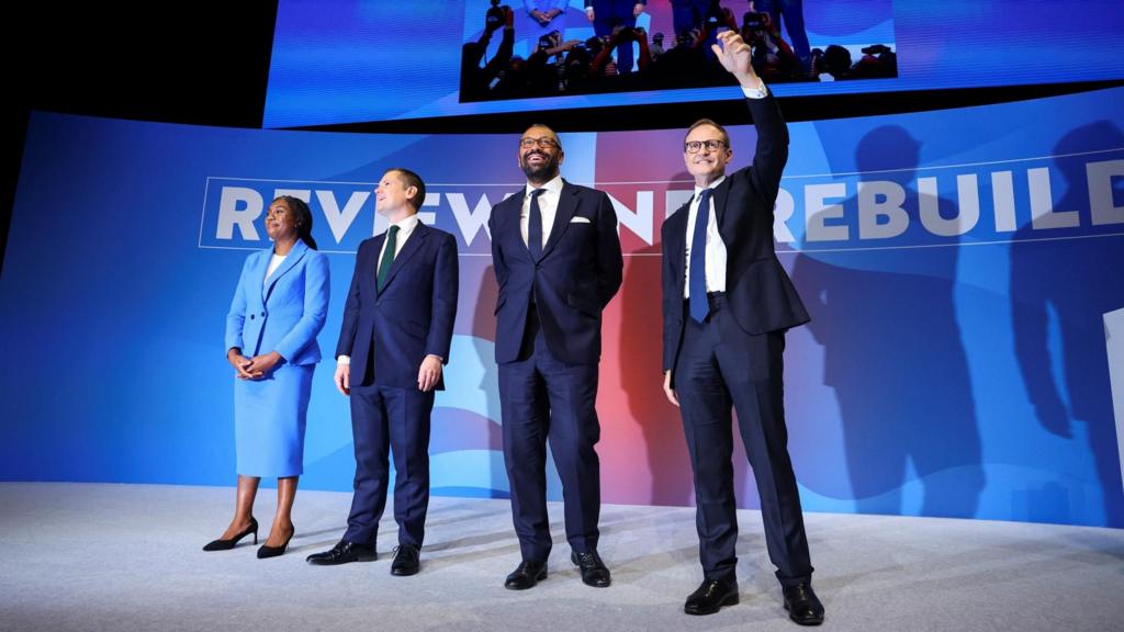 Conservative MPs and leadership candidates Kemi Badenoch, Robert Jenrick, Shadow Home Secretary James Cleverly and Tom Tugendhat stand together on stage on the final day of the Conservative Party conference in Birmingha