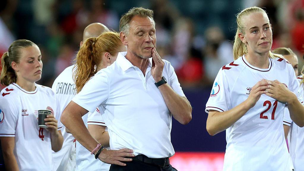 Andree Jeglertz closes his eyes in frustration while surrounded by dejected Denmark players