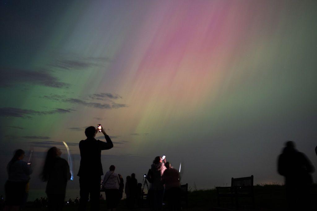 People looking at the Northern Lights. 