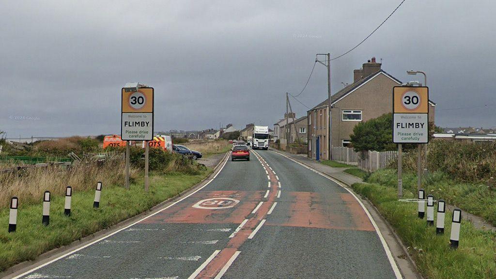 The road entering Flimby with signs warning of a 30mph speed limit.