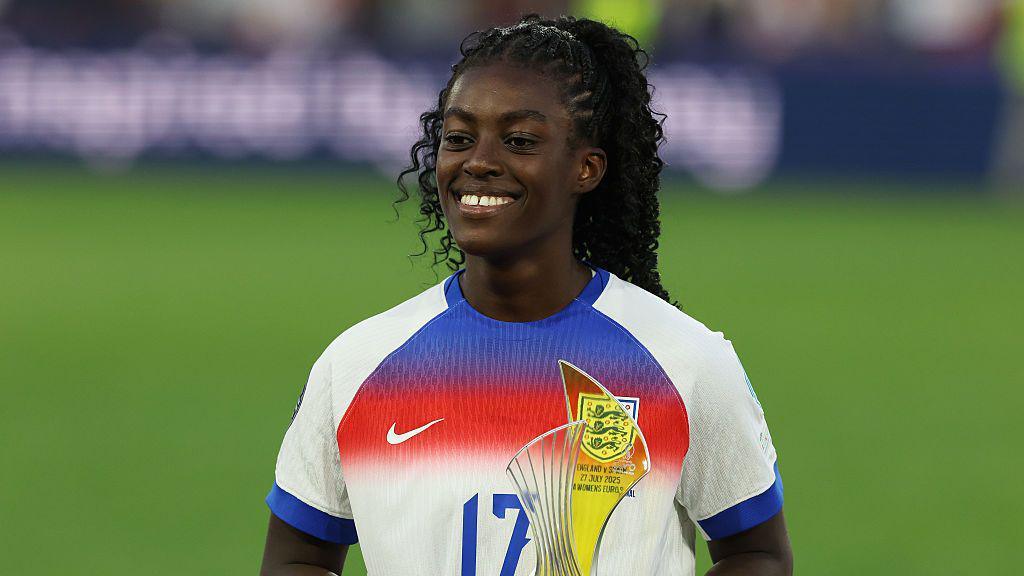 Michelle Agyemang holds a trophy while in the England kit after the Euro 2025 win