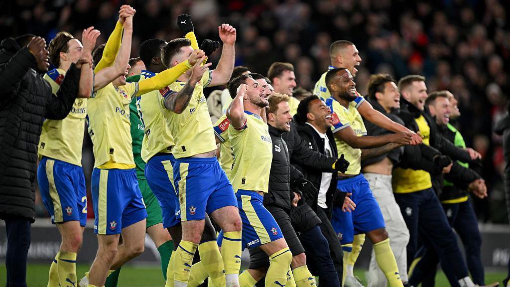 Southampton's players and staff celebrate as they beat Arsenal to progress in the FA Cup