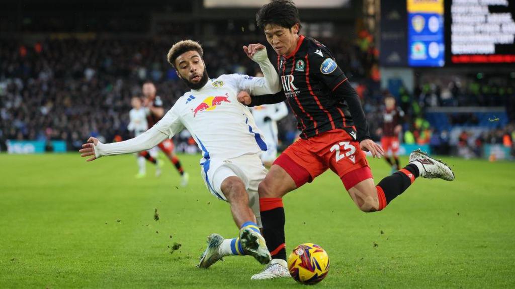 Leeds United's Jayden Bogle (left) lunges at Blackburn Rovers' Yuki Ohashi (right) during the New Years Day match