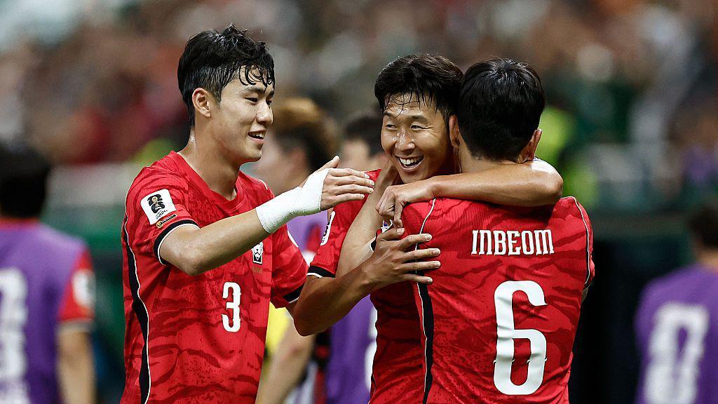 Hwang In-beom celebrates scoring South Korea's first goal with teammates Lee Gi-hyuk and Son Heung-min.