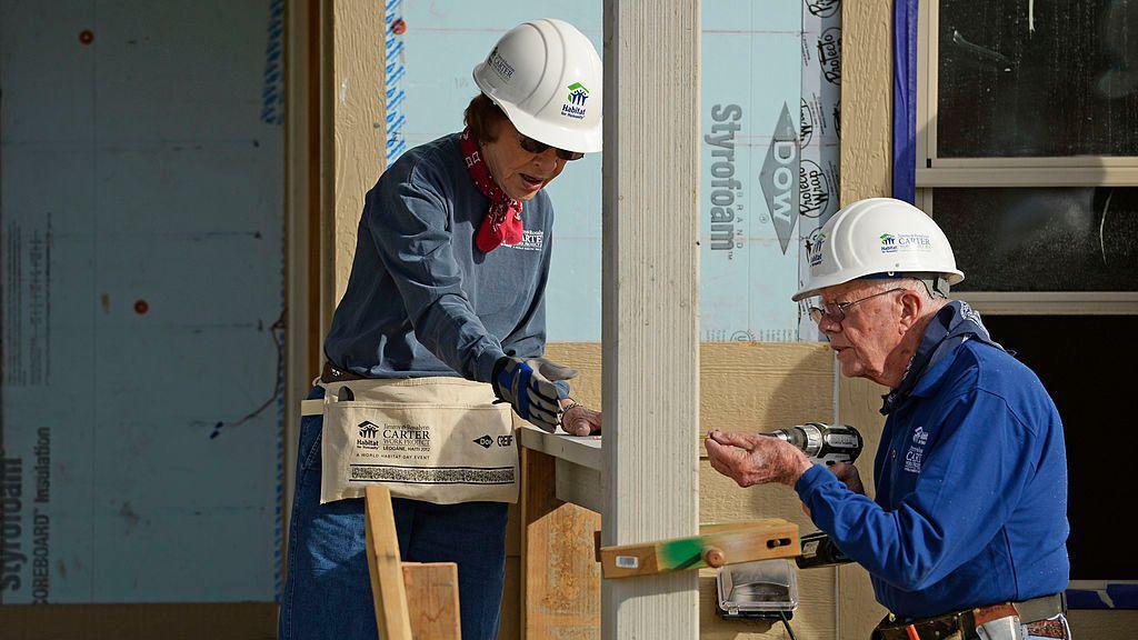 The Carters construct a home in 2013 as part of their volunteer work for Habitat for Humanity.