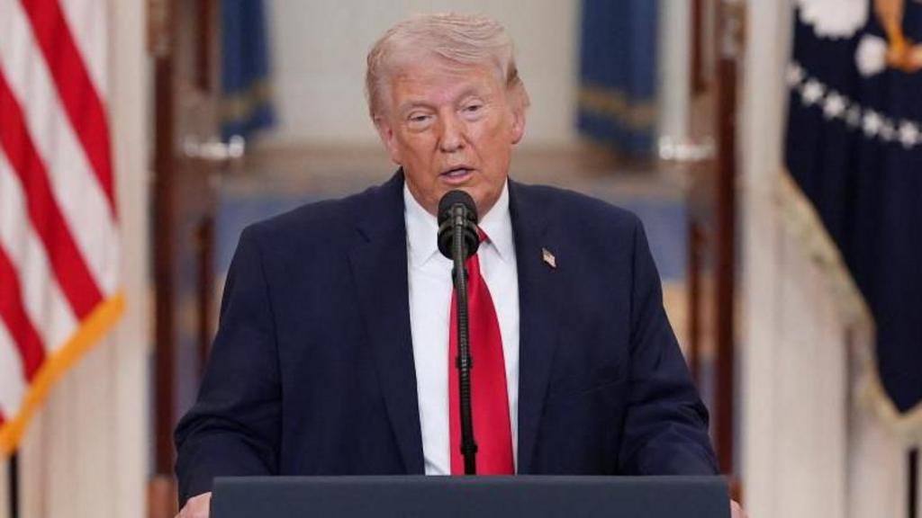 Donald Trump speaks from behind a podium in an official address to the nation.
