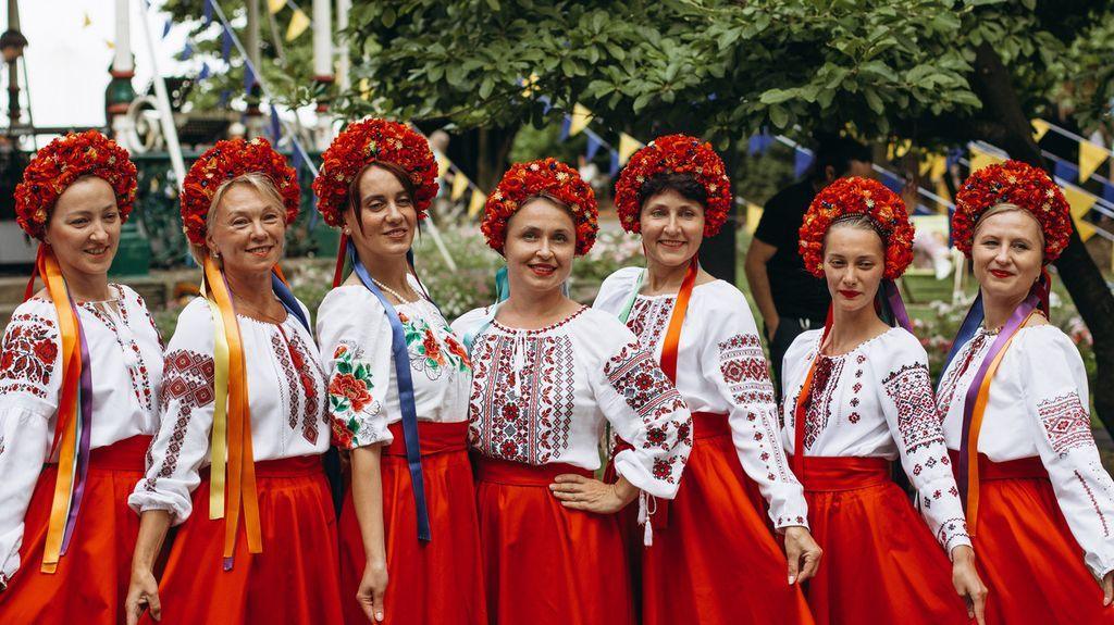 Ukrainian women dressed in red skirts and white decorated tops at last year's UkraineFest. They are also wearing red head dresses.