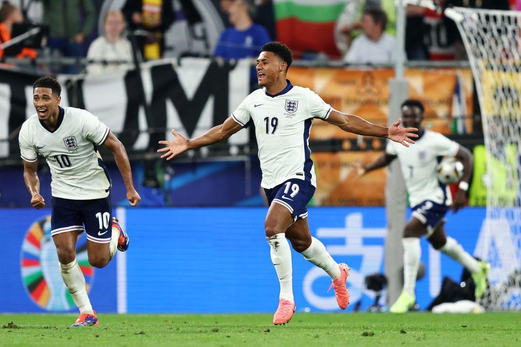 Ollie Watkins celebrates his goal with Jude Bellingham and Bakayo Saka.