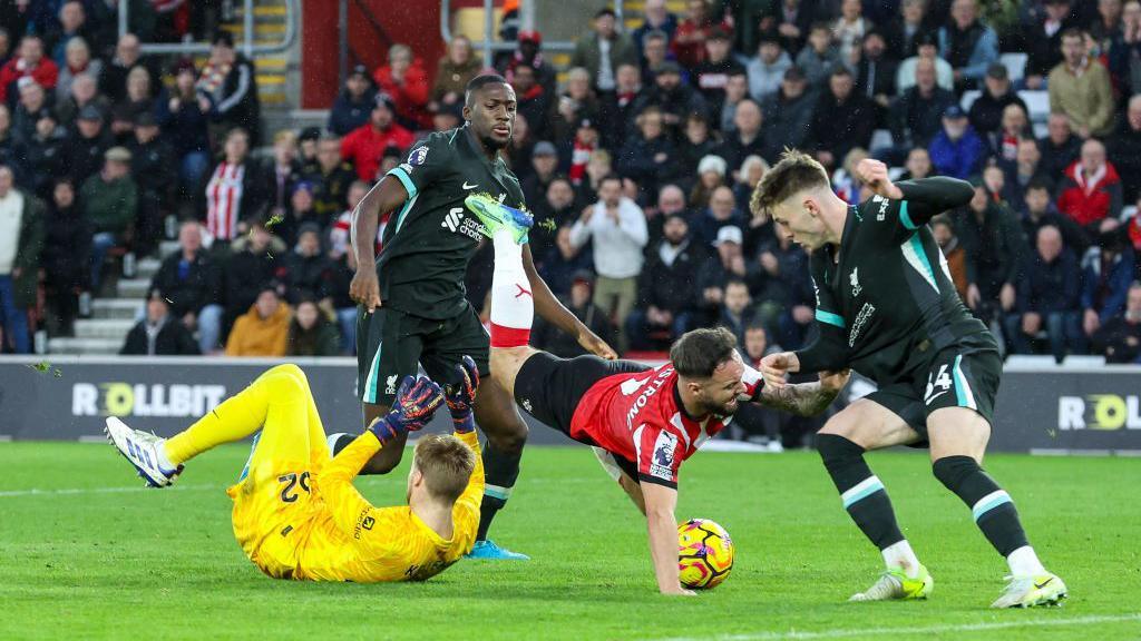 Caoimhin Kelleher of Liverpool blocks Adam Armstrong of Southampton