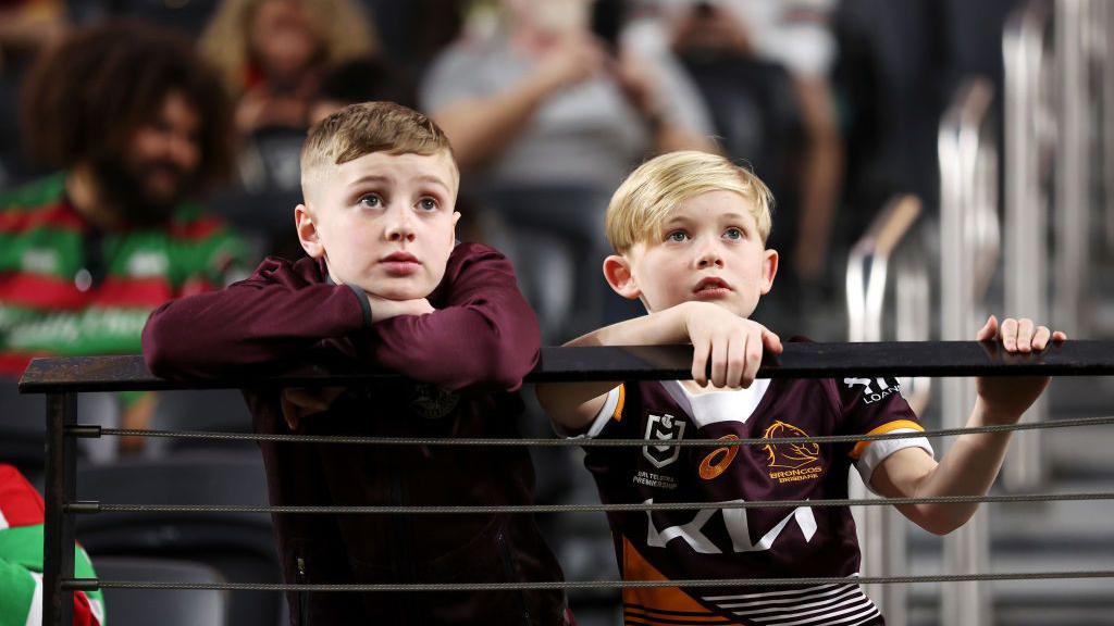 Young Broncos supporters looks on before the round one NRL match.