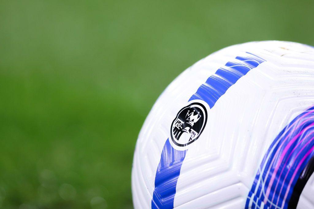 A Premier League-branded football ball sits on the turf before a match