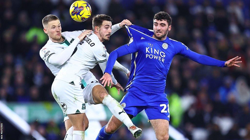 Tom Cannon (right) challenges for the ball against two Plymouth players on his Foxes debut