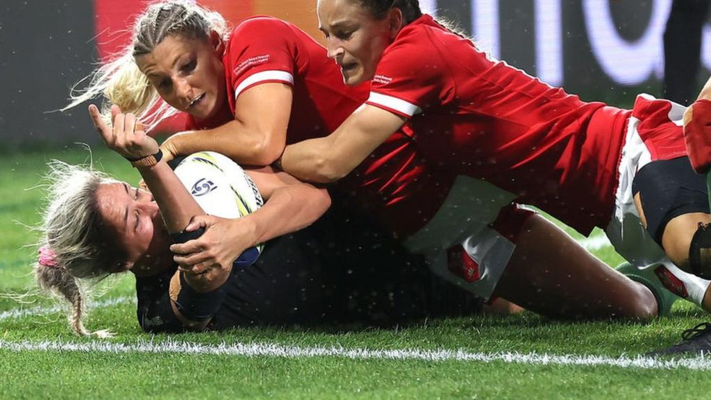 Sarah Hirini scores a try for New Zealand as Wales' Lowri Norkett and Jaz Joyce try to stop her