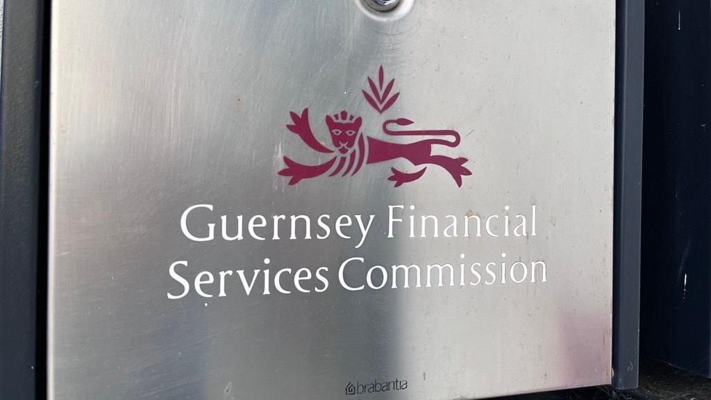 A sign for Guernsey Financial Services Commission with a red lion logo.