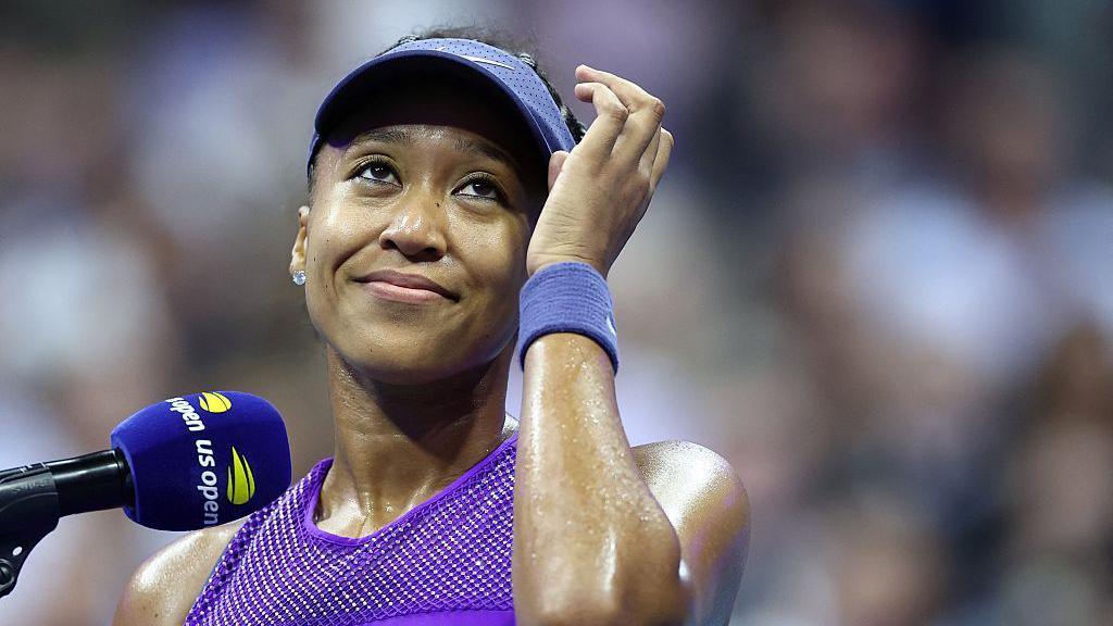 Japan's Naomi Osaka speaks on the court after defeating Czech Republic's Karolina Muchova