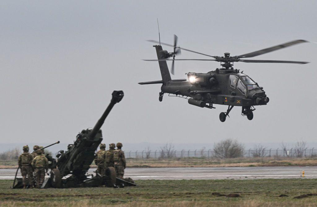 An Apache helicopter takes off during a demonstration on a military base