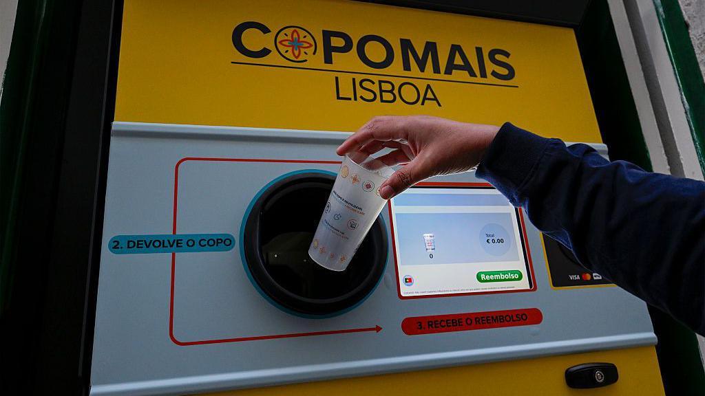 A reverse vending machine for plastic cups in Portugal. It has a computer screen which shows the total amount a person is being reimbursed