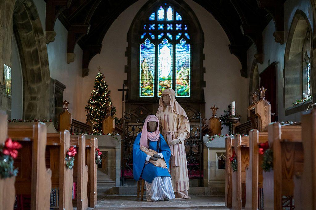 This display in a church shows a Christmas scene of Mary and Joseph with baby Jesus